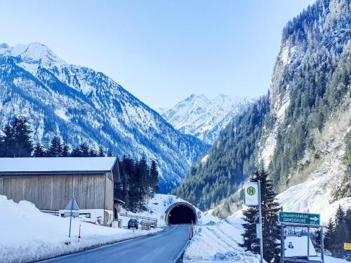 a road leading into a tunnel in the mountains at Apartment Wandegg by Interhome in Ginzling
