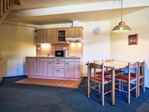 a kitchen and dining room with a table and chairs at Apartment Harrachov 613-2 by Interhome in Harrachov