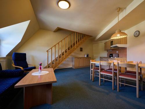 a living room with a table and a staircase at Apartment Harrachov 613-2 by Interhome in Harrachov