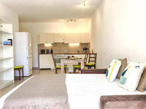 a bedroom with a large bed and a kitchen at Studio Alpes et Lac 14 by Interhome in Champex