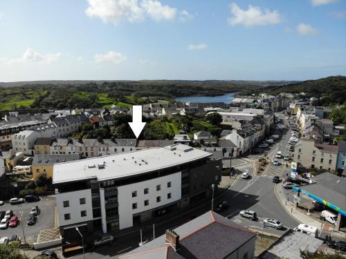 an aerial view of a town with a white arrow at 12 Courthouse Square in Clifden