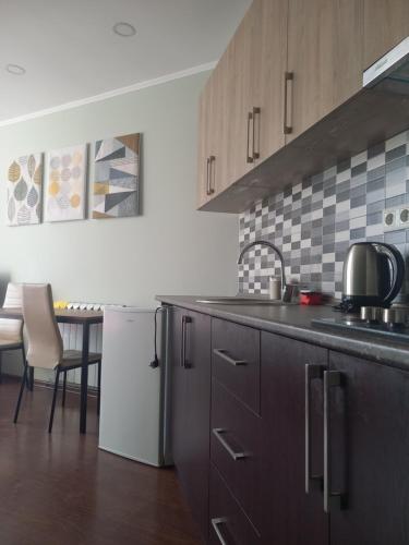 a kitchen with a sink and a counter top at Batumi view center in Adliye