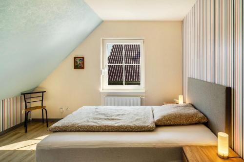 a bedroom with a bed and a window at Ferienhaus Wiesmoor in Wiesmoor