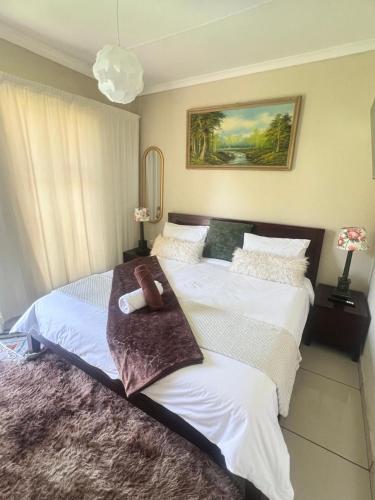a bedroom with two beds with towels on them at 17 Byvanger Luxury Home Deluxe King Suite Room 3 in Centurion
