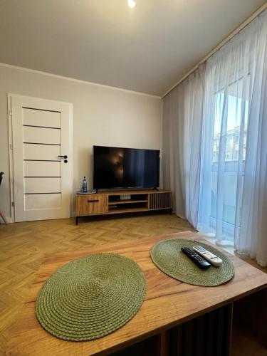 a living room with a television and a table at Apartament Podolszyce 14 in Płock