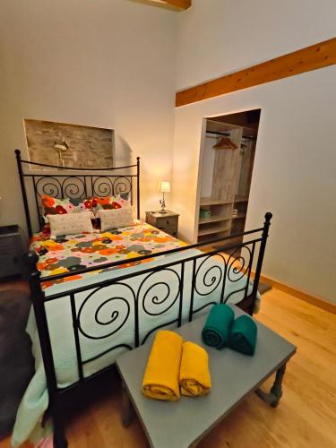 a bedroom with a bed with a table and a mirror at Azoka by the Sea- Centro Histórico de Peniche in Peniche