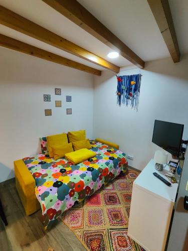 a bedroom with a colorful bed and a desk at Azoka by the Sea- Centro Histórico de Peniche in Peniche