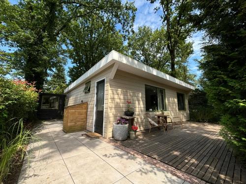 a small house with a patio in front of it at Huisje de Haeg in Ermelo