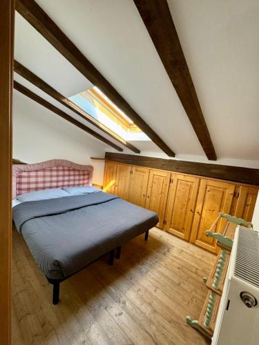 a bedroom with a bed in a attic at Brici's House 69 - Mountain Apartment Tonale in Passo del Tonale