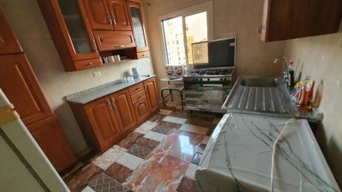 a kitchen with a sink and a stove top oven at شقة فاخرة لعائلة بالمهندسين in Cairo