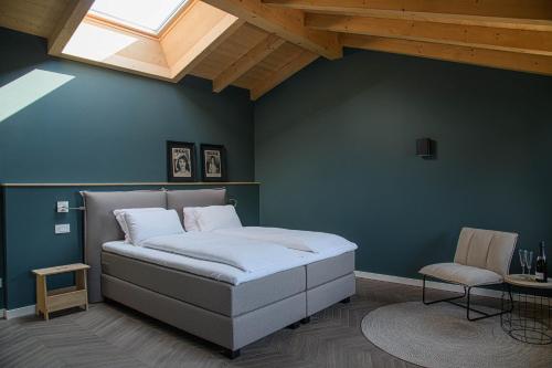 a bedroom with a bed and a skylight at GardaZen Suites - luxury - adults only in Caprino Veronese
