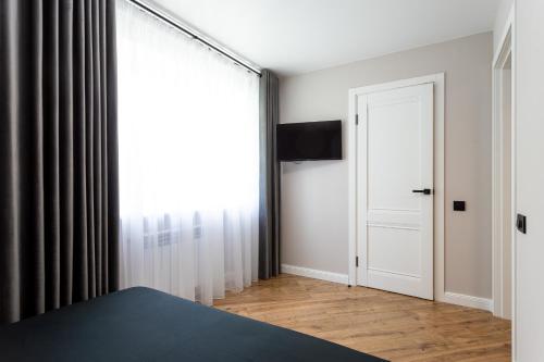a room with a bed and a window and a door at NEW!!!Новая двухкомнатная квартира в самом центре города in Mykolaiv