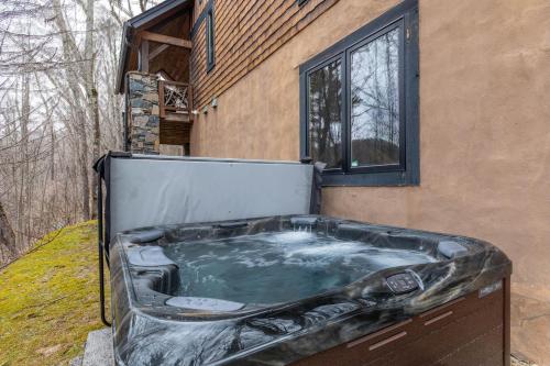 a hot tub sitting outside of a house at Rustic Cedar Rock Townhome at Eagles Nest in Banner Elk