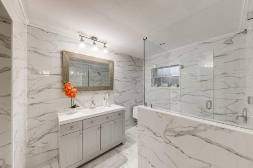 a white bathroom with a sink and a shower at Boca Raton Home Outdoor Kitchen, By Golf Courses in Boca Raton