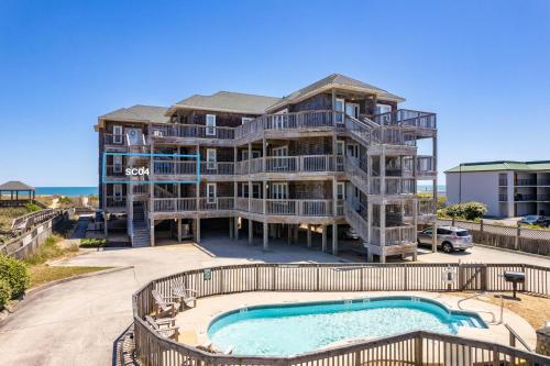 an apartment building with a swimming pool and a condo at SC04 Sand Castle 4 in Kill Devil Hills