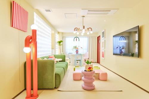 a living room with a couch and a table at 寅ホテル 御徒町 TORA HOTEL Okachimachi in Tokyo