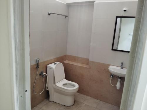 a bathroom with a toilet and a sink at Sankara Residency in Kanchipuram