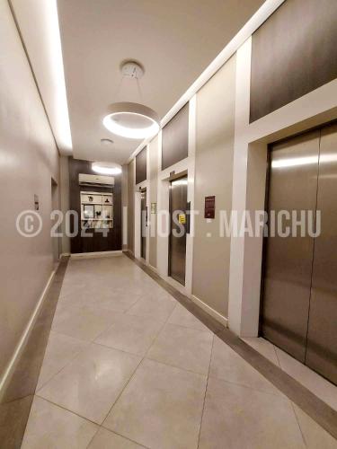 a corridor in a building with a hallway at AVIDA TOWERS RIALA 2BR Condo in IT Park Cebu City in Carreta