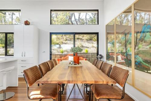 a dining room with a wooden table and chairs at Majestic Mountain View in Katoomba in Katoomba