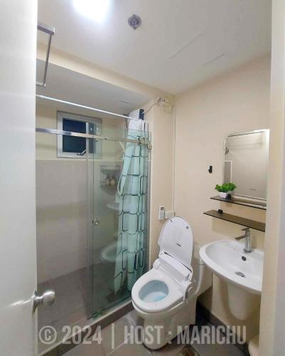 a bathroom with a shower and a toilet and a sink at AVIDA TOWERS RIALA 2BR Condo in IT Park Cebu City in Carreta