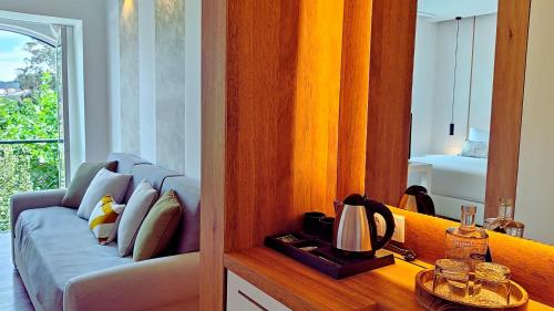a living room with a couch and a window at Grande Hotel das Caldas da Felgueira in Caldas da Felgueira