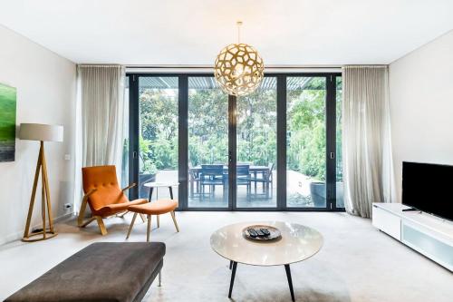 a living room with a couch and a table at Leafy Inner City Apartment Camperdown in Sydney