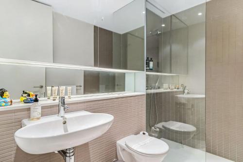 a bathroom with a sink and a toilet at Leafy Inner City Apartment Camperdown in Sydney