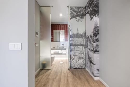 a bathroom with a toilet and a wall mural at King David Suites by Homie in Funchal