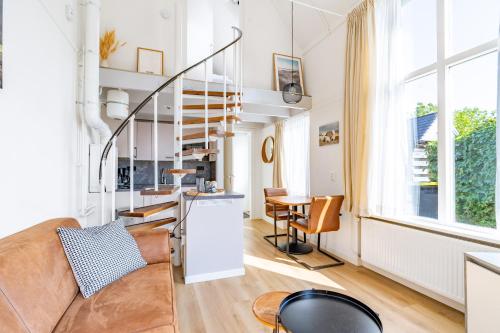 a living room with a couch and a table at Plevierstraat 3a in De Koog