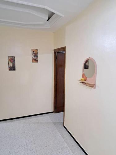 a room with a door and a mirror on a wall at Appartement Atlas City Center 2 in Fès