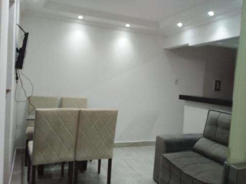 a living room with a couch and a table and chairs at Apto 2 quartos Nucleo Bandeirante in Brasilia