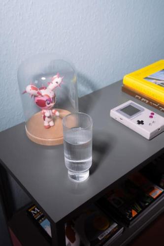 a glass of water sitting on a table with a glass of water at Green Forest Bungalow in Weiperfelden