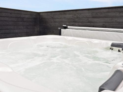 a white bath tub sitting on top of a roof at Luxury Retreat in Romo - By Traum Ferienwohnungen in Kongsmark