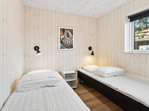 a bedroom with two beds and a window at Luxury Retreat in Romo - By Traum Ferienwohnungen in Kongsmark