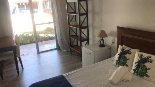 a bedroom with a bed and a book shelf at Santa Hospedaria Beach in Bertioga