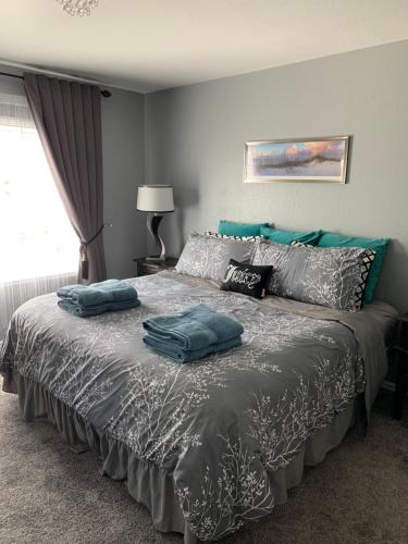 a bedroom with a bed with two pillows on it at Charming 3 bed 3 bath home, super cozy, close to DIA in Altura