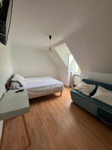 une chambre avec un lit et une table dans une pièce dans l'établissement CHAMBRE de LUXE, à Nandy