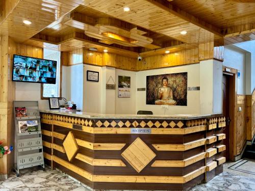 a bar in a room with wooden walls at Hotel Jogini Height's - Chandra A S Hospitality in Vashisht