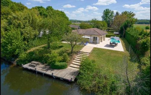 an aerial view of a house next to a river at Villa la Rive, River Villa in Le Temple-sur-Lot