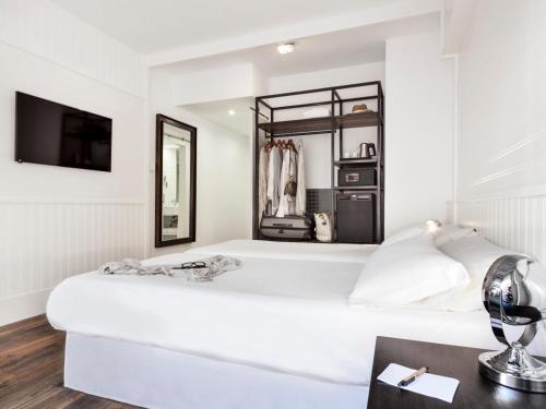 a white bedroom with a large white bed and a mirror at Delamar 4*Sup-Adults only (18+) in Lloret de Mar