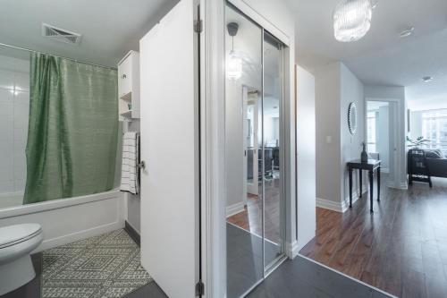 a bathroom with a shower and a toilet at Spacious 2 Bedroom plus Den, 2 Bath, Sleeps 5 with Balcony and Lakeview Downtown Toronto Condo in Toronto