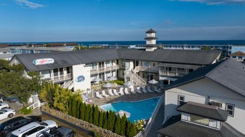 an aerial view of a hotel with a pool and a lighthouse at A Wave Inn - Montauk in Montauk