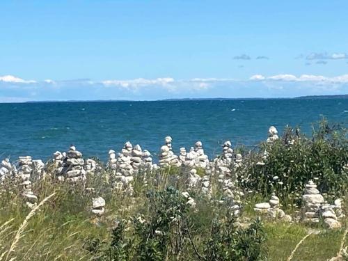 a group of white rocks on a hill near the ocean at Charming Nykøbing Sjælland Summerhouse in Nykøbing Sjælland