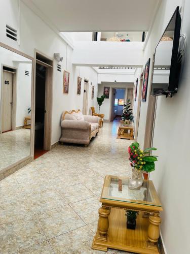 a living room with a couch and a table at Hotel Tonchala Centro in Armenia