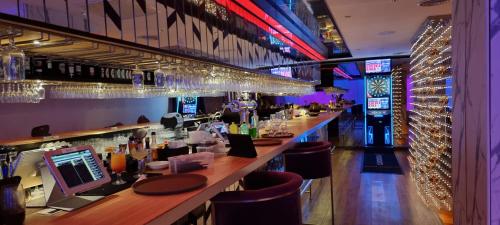 a bar with a long counter with bar stools at Star KLCC Elegant 2-3pax by DingDing in Kuala Lumpur
