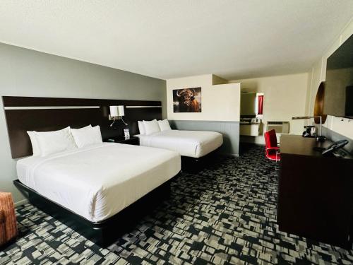 a hotel room with two beds and a desk at Americas Best Value Inn Wall in Wall