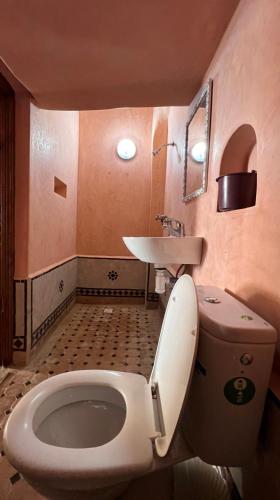 a bathroom with a toilet and a sink at Little Paradise House in Agadir