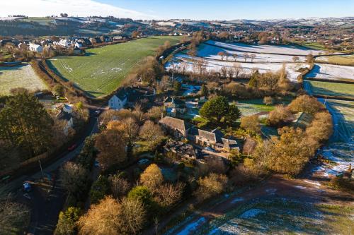 an aerial view of a village with houses and trees at The Old Coach House - Converted barn with private garden parking and fireplace in Totnes
