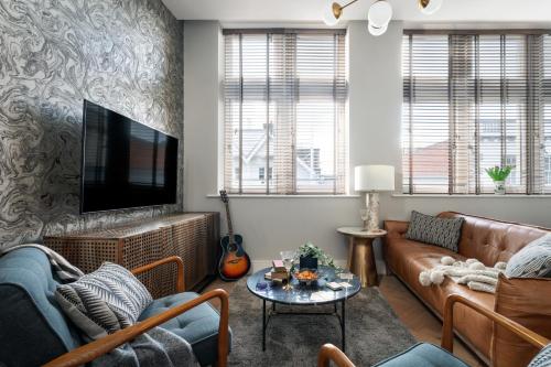 a living room with two couches and a tv at Cathedral Yard - Art Deco Luxury (Exeter) in Dean
