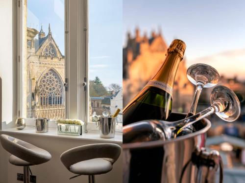 a bottle of wine in a bucket next to a window at Cathedral View - An Exclusive Private Apartment on Cathedral Green, Exeter in Exeter